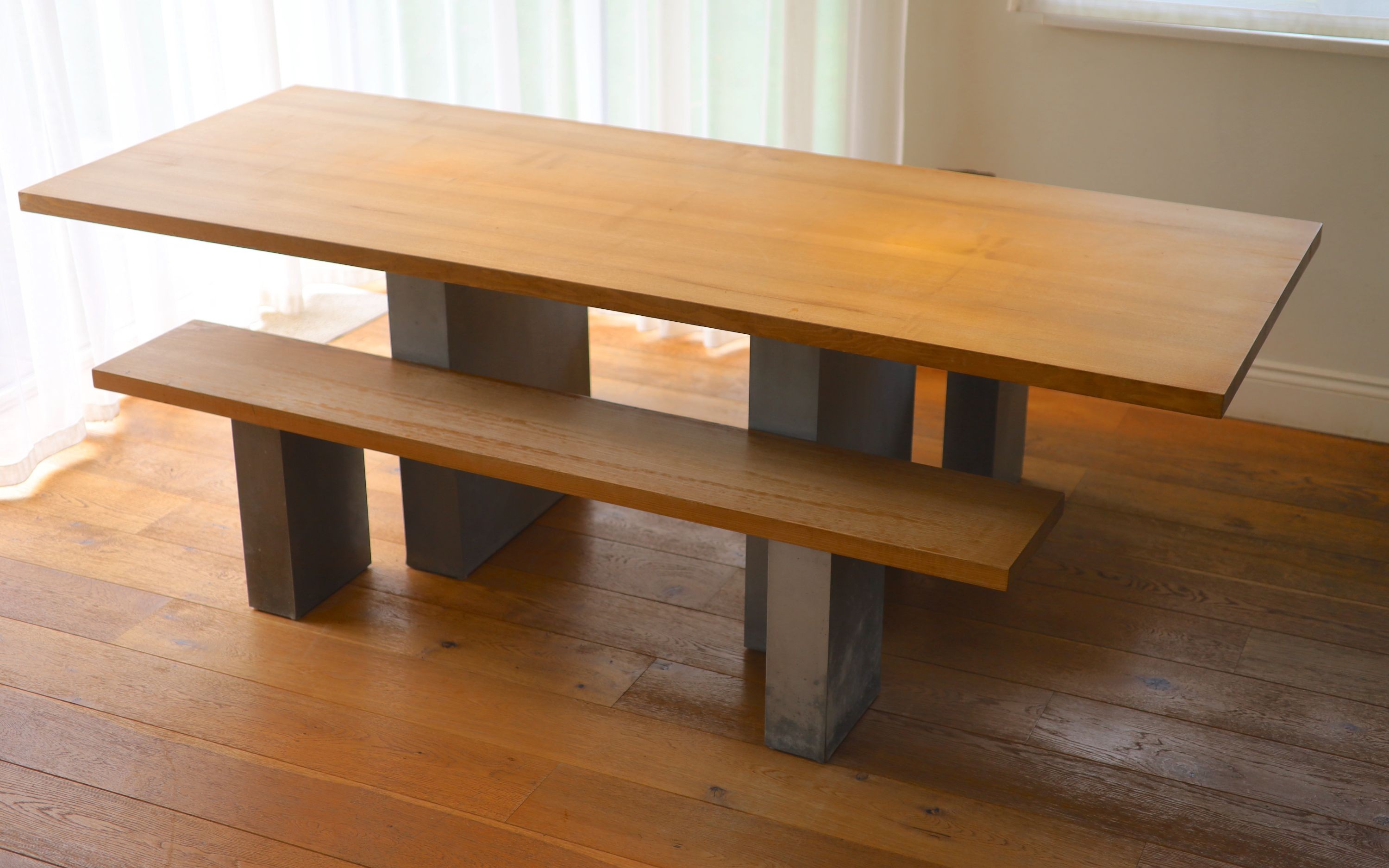 A contemporary oak kitchen table with pair of matching benches and oxidised metal supports, table width 230cm depth 90cm height 74cm, benches width 180cm